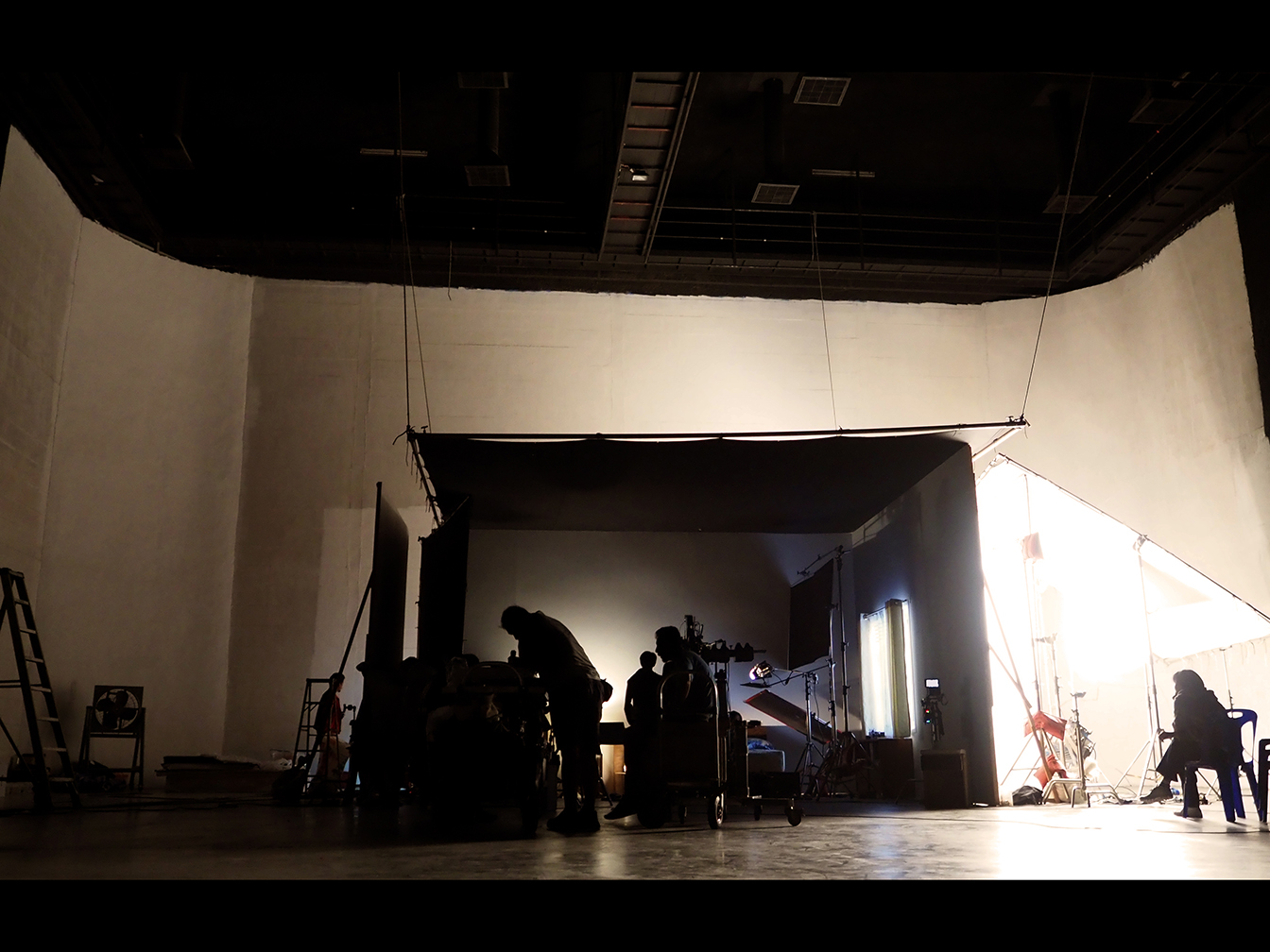 Behind the shooting production crew team and silhouette of camer