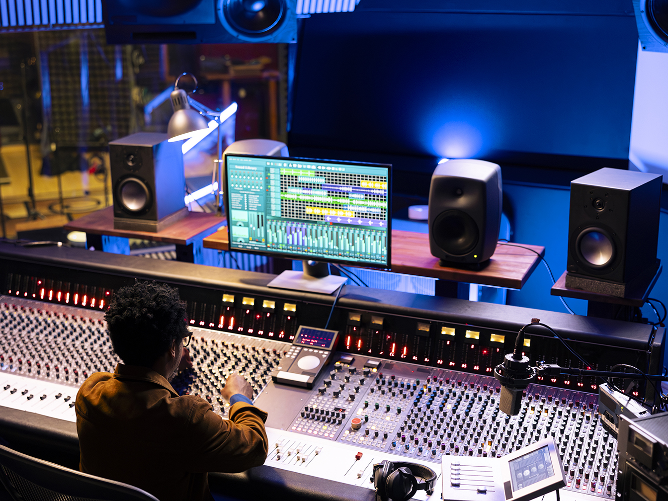 African american audio expert editing tunes with digital software on pc